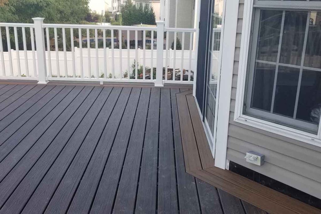 Brown decking in back of contemporary home